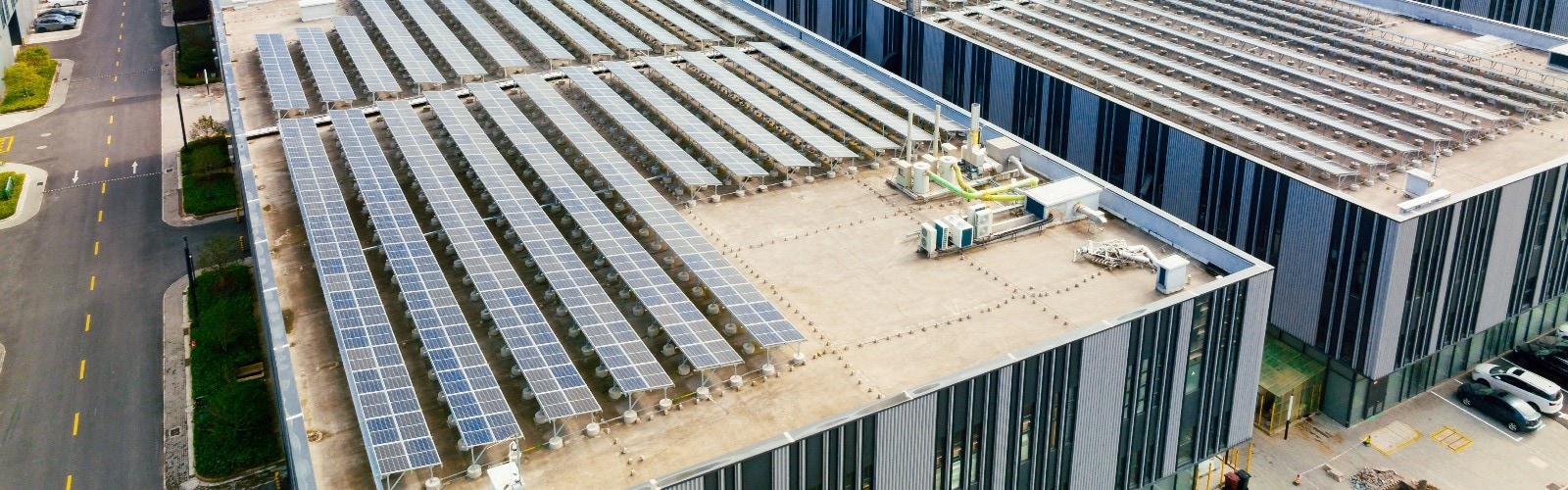 Two men placing solar panels on a roof